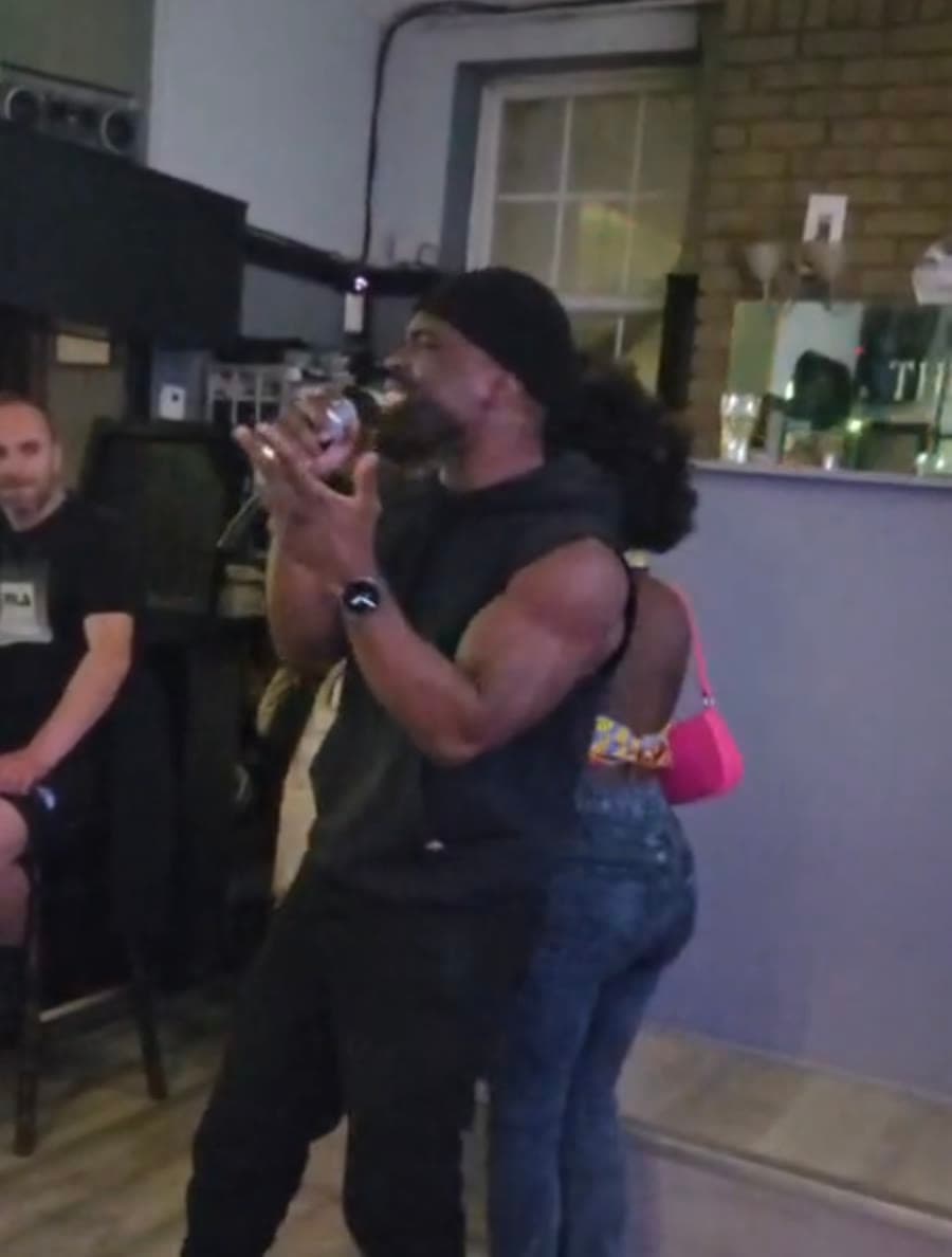 Doja rapping into a microphone