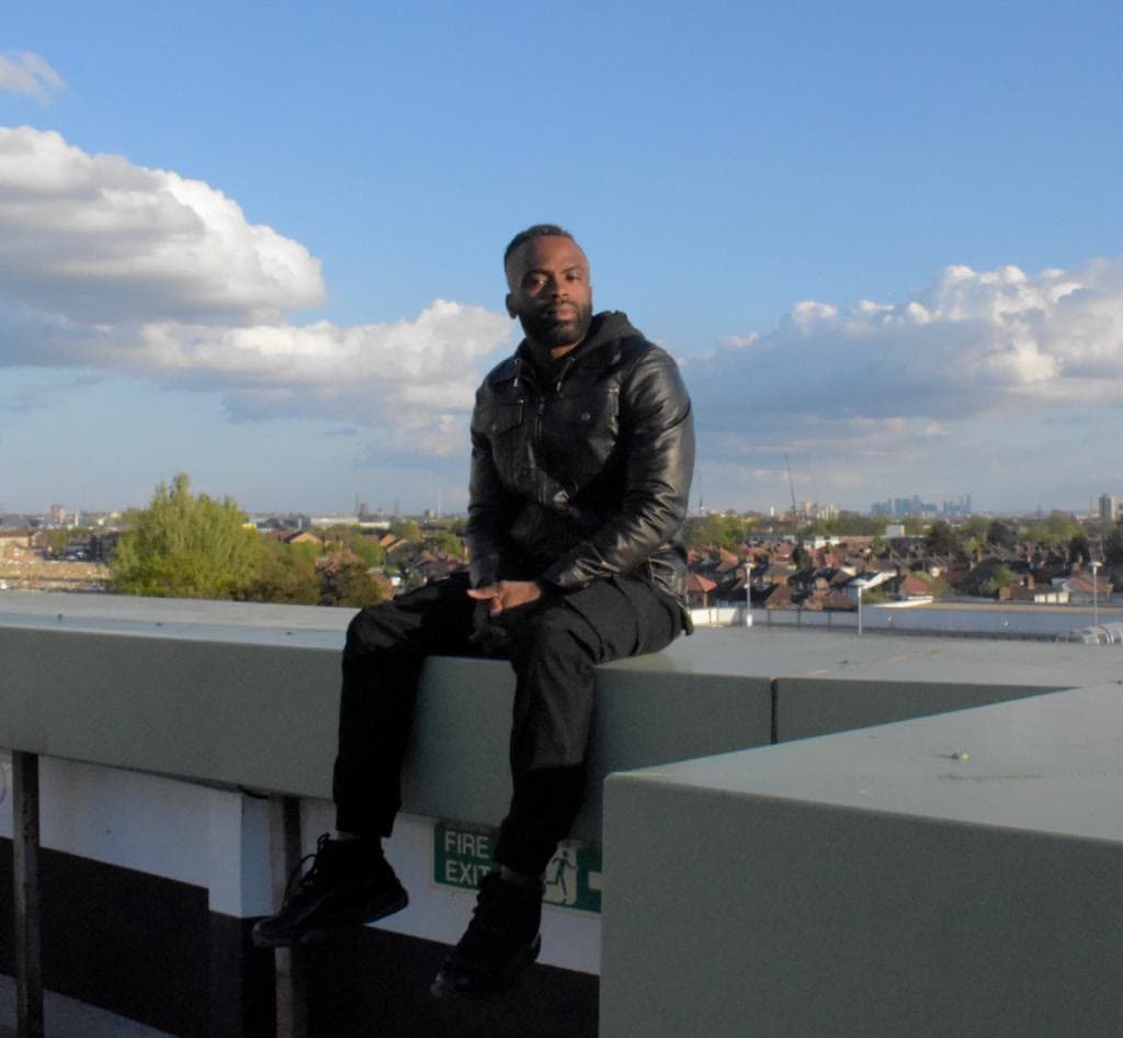 Doja on a rooftop overlooking the city
