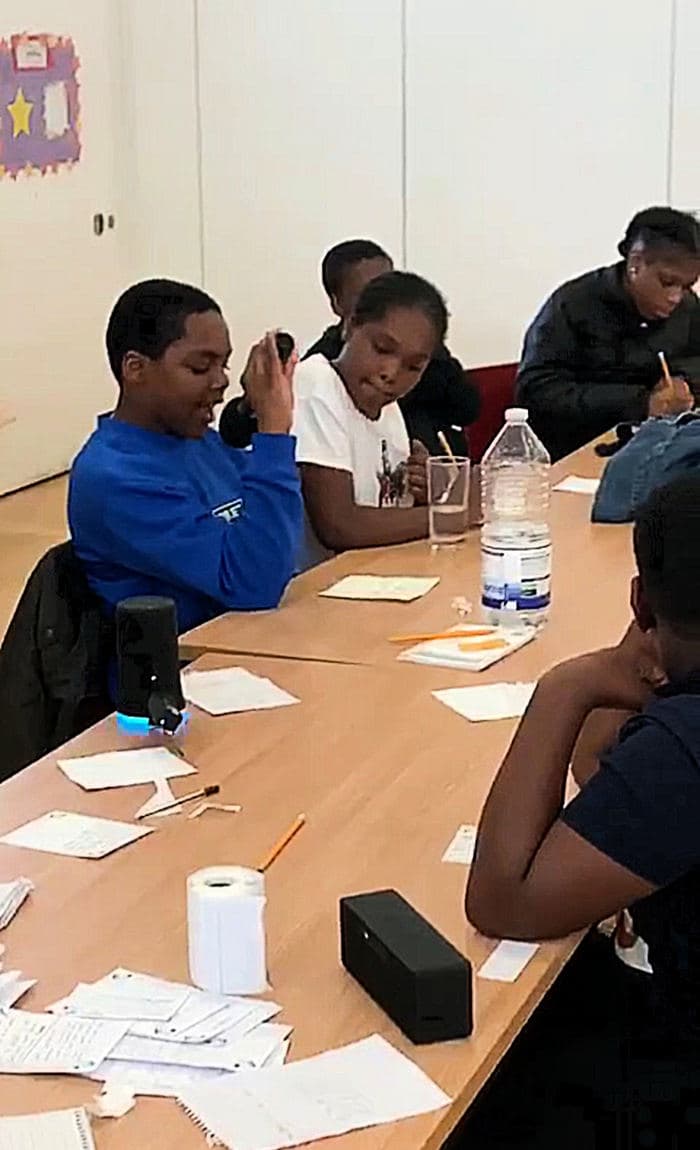 A group writing lyrics around a table