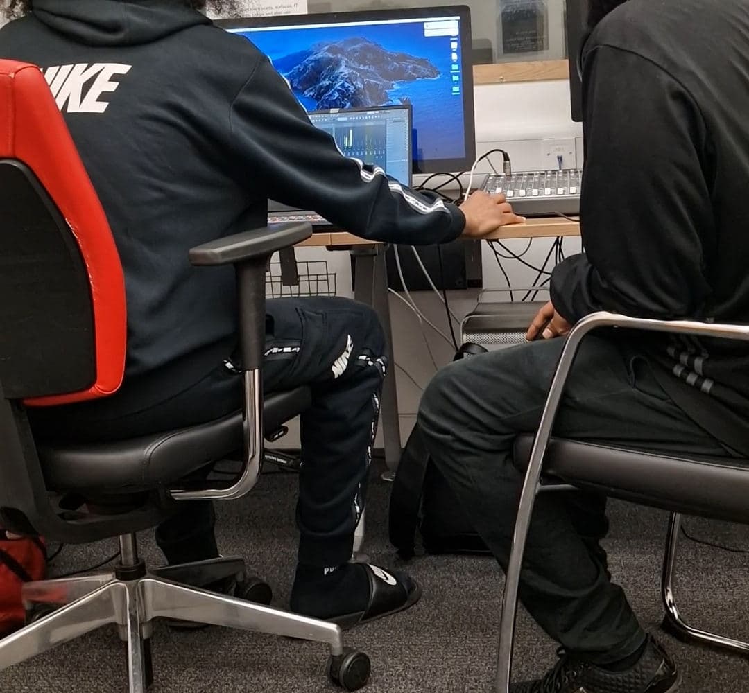 A learner producing a beat on a computer